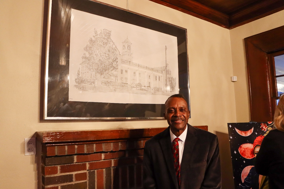 Larry Boone posing with artwork