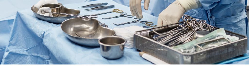 Photo of a surgeons hands over various tools