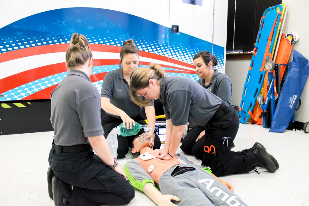 Emergency medical science students performing CPR