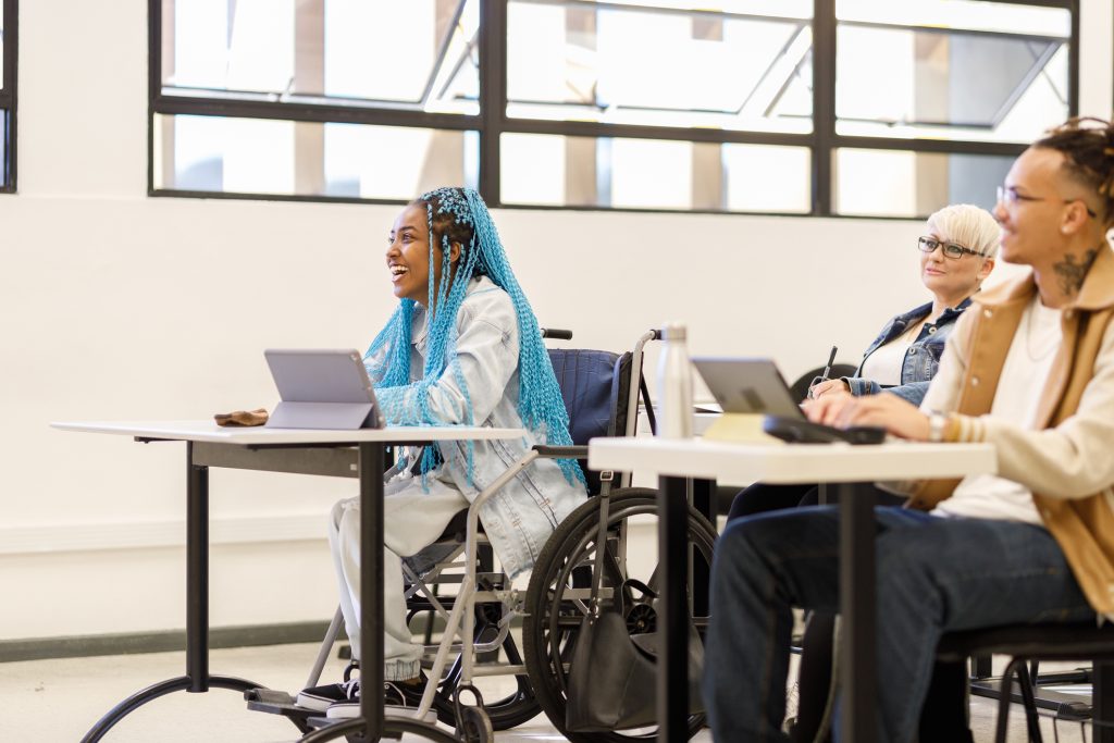 Student in a wheelchair enjoying learning in class