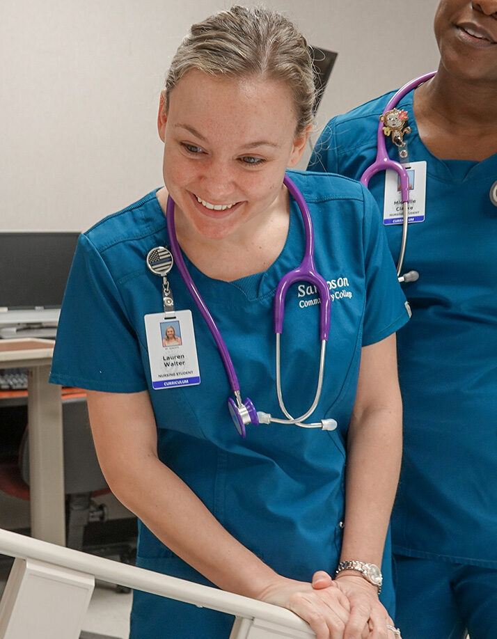 LPN students working with a mannequin